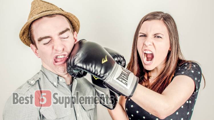 A man being punched by a woman with a boxing glove to show the dangers of stimulants in fat burners